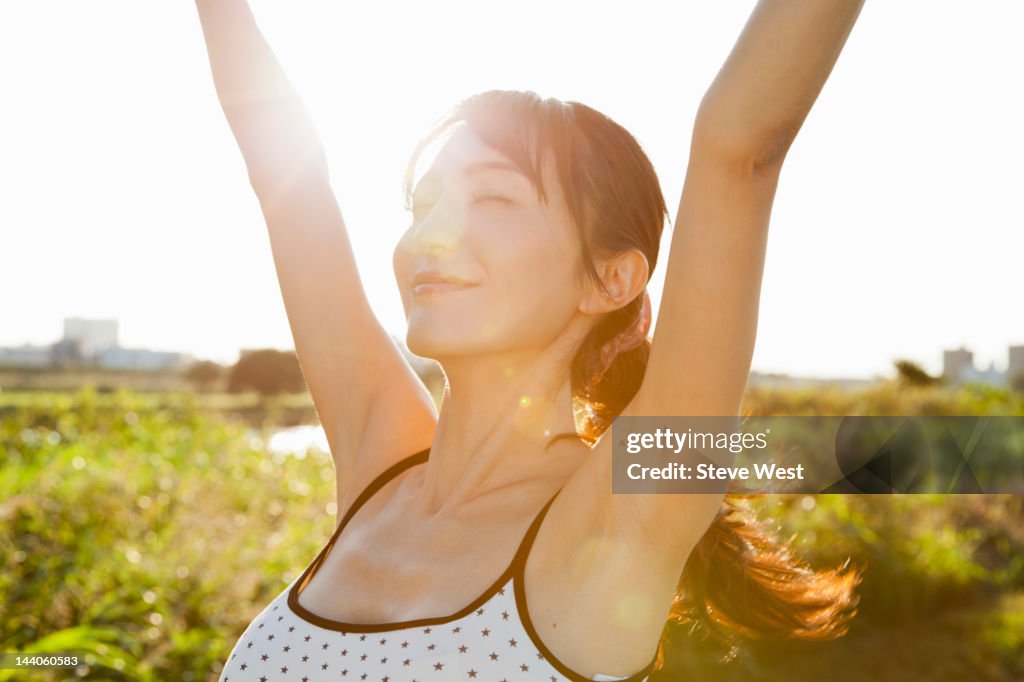 Athletic woman stretching in nature