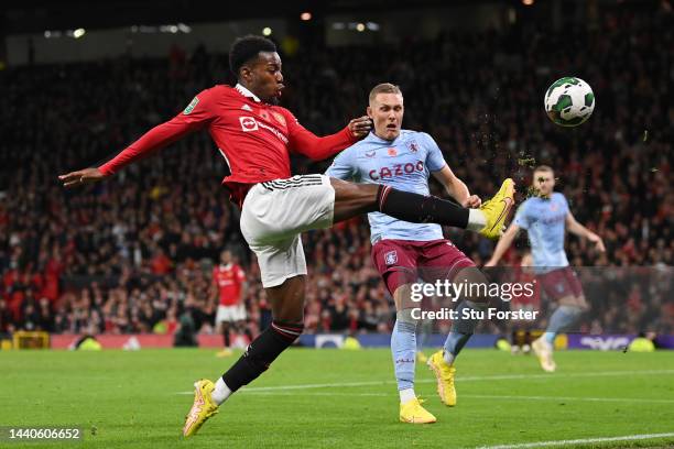 Anthony Elanga of Manchester United stretches to control the ball under pressure from Ludwig Augustinsson of Aston Villa during the Carabao Cup Third...