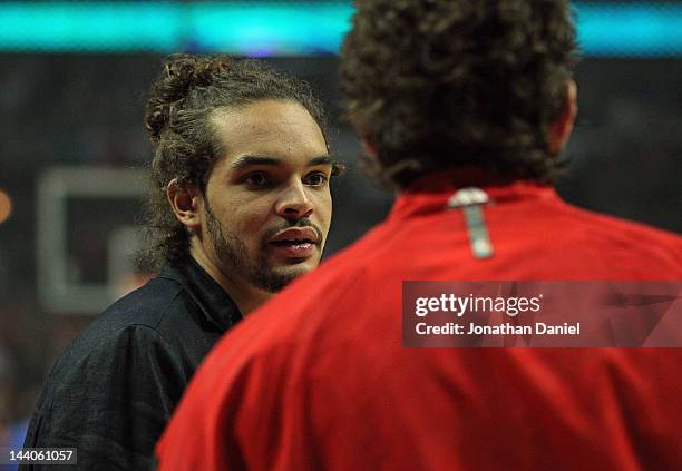 Joakim Noah of the Chicago Bulls talks with teammate Omer Asik before the Bulls take on the Philadelphia 76ers in Game Five of the Eastern Conference...