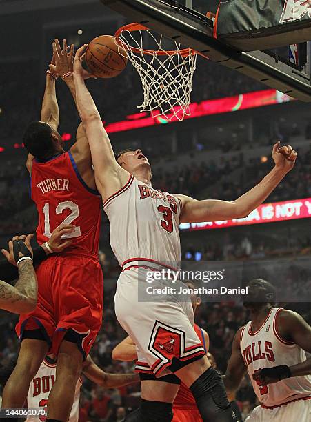 Omer Asik of the Chicago Bulls grabs the ball away from Evan Turner of the Philadelphia 76ers in Game Five of the Eastern Conference Quarterfinals...