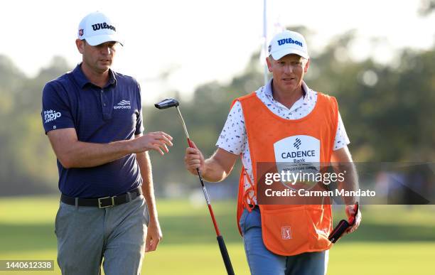 Brendan Steele of the United States walks on the eight hole with his caddie Christian Donald during the first round of the Cadence Bank Houston Open...