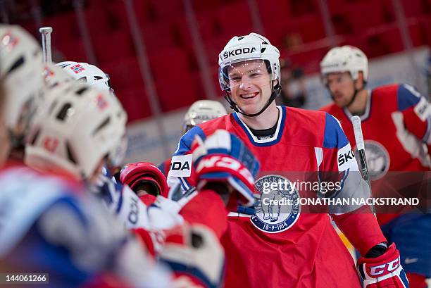 Norway's Marius Holtet celebrates with his teammates after scoring against Italy during their preliminary round match at the Ice Hockey World...