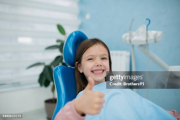 happy little girl at the dentist - orthodontist stock pictures, royalty-free photos & images