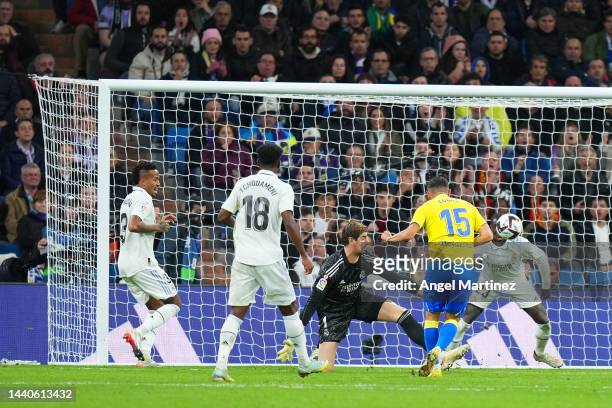 Lucas Perez of Cadiz CF scores their team's first goal past Thibaut Courtois of Real Madrid during the LaLiga Santander match between Real Madrid CF...