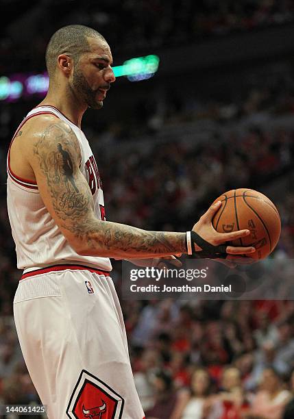 Carlos Boozer of the Chicago Bulls hands the ball to a referee during a free-throw against the Philadelphia 76ers in Game Five of the Eastern...