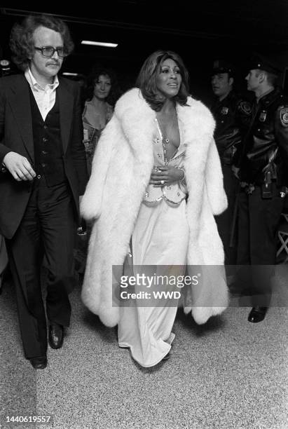Tina Turner in white fur coat at the opening party for "Tommy"