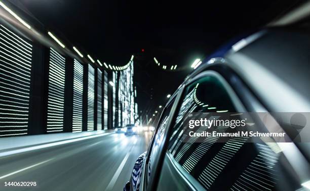 fast driving hybrid car on san francisco bay bridge while night. - oakland bay bridge fotografías e imágenes de stock