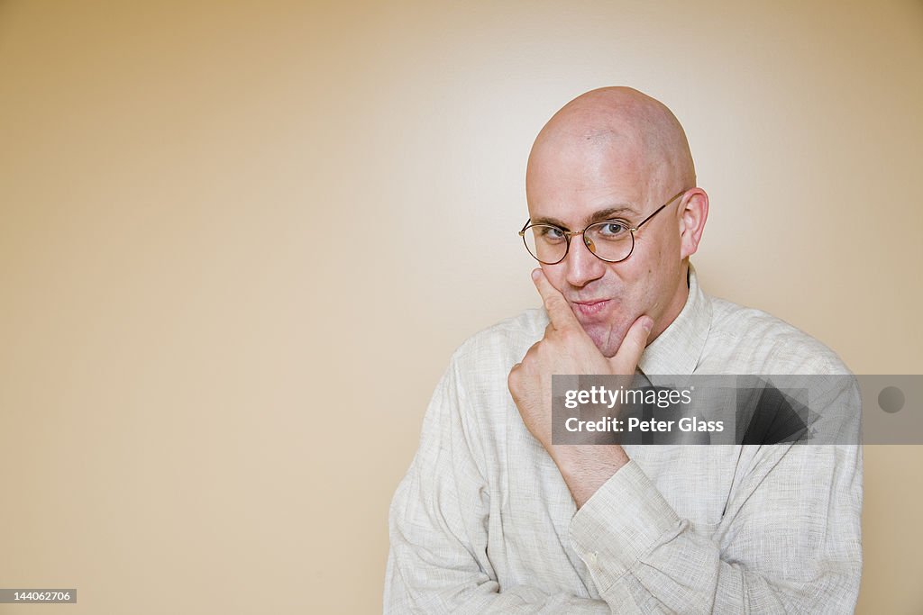 Middle-age bald man wearing glasses.