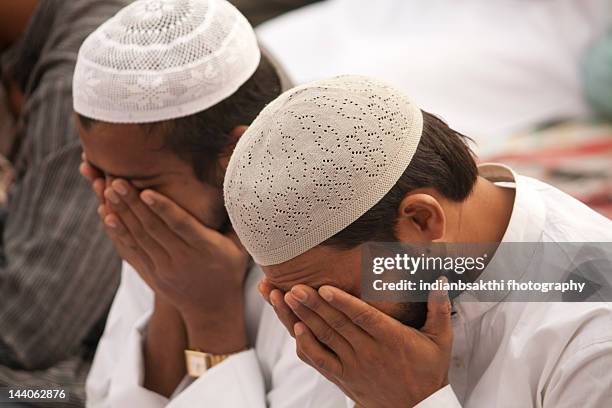 men on prayer - muslim prayer stock pictures, royalty-free photos & images