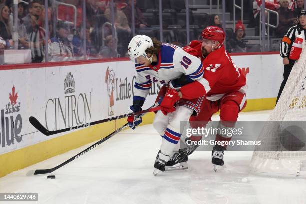 Artemi Panarin of the New York Rangers battles for the puck against Filip Hronek of the Detroit Red Wings during the first period at Little Caesars...