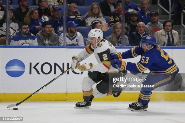 Zach Whitecloud of the Vegas Golden Knights skates against Jeff Skinner of the Buffalo Sabres during the first period of an NHL hockey game at...