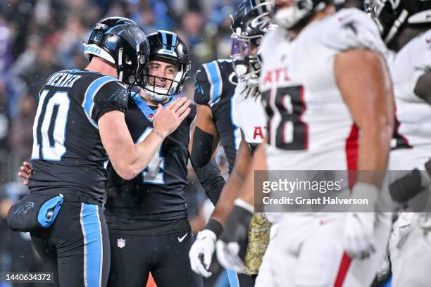 Johnny Hekker of the Carolina Panthers celebrates with Eddy Pineiro of the Carolina Panthers after Pineiro's field goal during the first quarter...