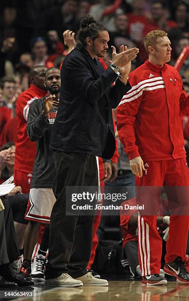 Joakim Noah of the Chicago Bulls, injured in game three against the Philadelphia 76ers, cheers teammates in Game Five of the Eastern Conference...