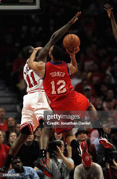 Evan Turner of the Philadelphia 76ers tries to shoot against Ronnie Brewer of the Chicago Bulls in Game Five of the Eastern Conference Quarterfinals...