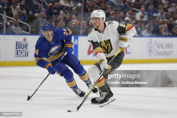 Jack Eichel of the Vegas Golden Knights skates against Dylan Cozens of the Buffalo Sabres during the second period of an NHL hockey game at KeyBank...