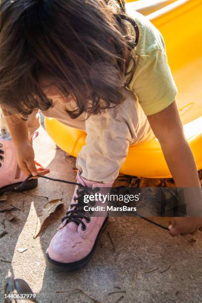little girl tying her shoelaces - shoelace stock pictures, royalty-free photos & images