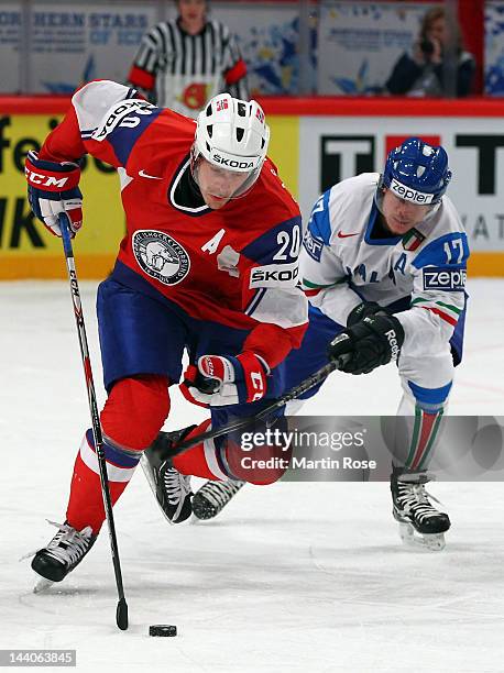 Anders Bastiansen of Norway and Alexander Egger of Italy battle for the puck during the IIHF World Championship group S match between Norway and...