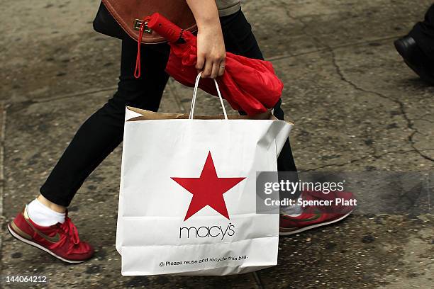 Woman carries a Macy's shopping bag in front of the flagship store on May 9, 2012 in New York City. Beating Wall Street's expectations, Macy's Inc....