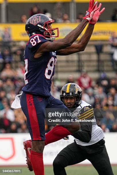 Eugene Lewis of the Montreal Alouettes goes up to make a pass reception against Ciante Evans of the Hamilton Tiger-Cats at Percival Molson Stadium on...