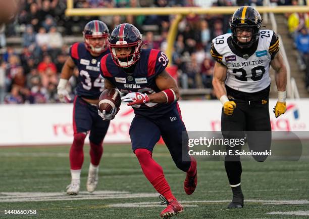 Chandler Worthy of the Montreal Alouettes returns a punt as Grant McDonald of the Hamilton Tiger-Cats pursues at Percival Molson Stadium on November...