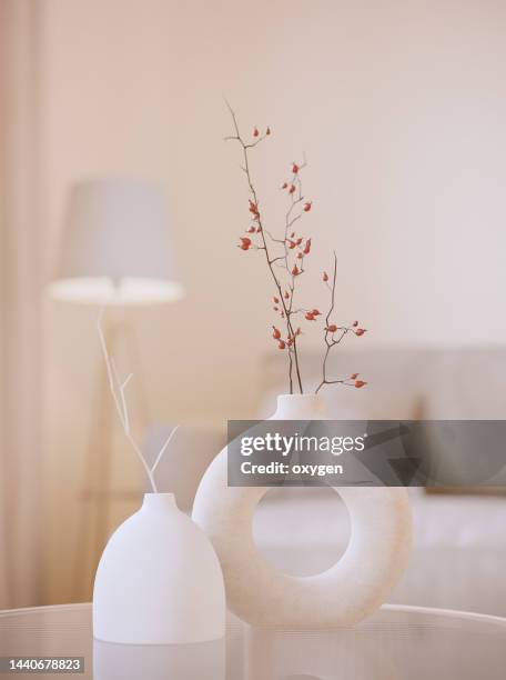 two modern white vases with brunches.  white 3d rendering objects with blured interior background. minimalism japandi or scandinavian boho style - flower vase stock pictures, royalty-free photos & images