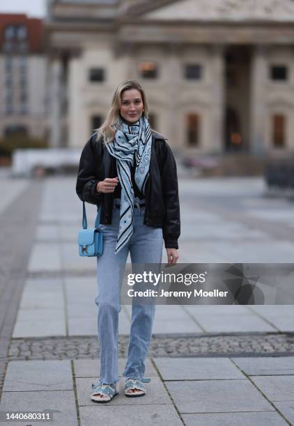 Mandy Bork wearing Agolde blue jeans, Hermes Kelly black leather silver belt, Hermes Constance baby blue leather bag, Hermes fur baby blue Chypre...