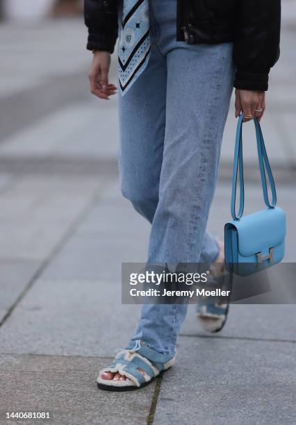 Mandy Bork wearing Agolde blue jeans, Hermes Kelly black leather silver belt, Hermes Constance baby blue leather bag, Hermes fur baby blue Chypre...
