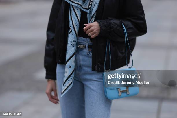 Mandy Bork wearing Agolde blue jeans, Hermes Kelly black leather silver belt, Hermes Constance baby blue leather bag, Hermes blue scarf, Anine Bing...