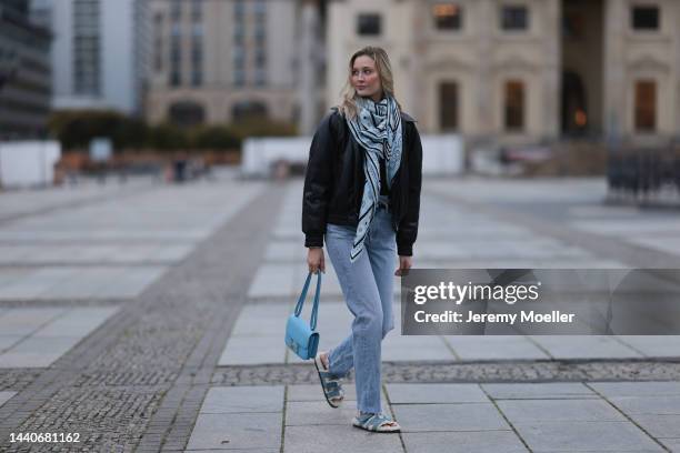 Mandy Bork wearing Agolde blue jeans, Hermes Kelly black leather silver belt, Hermes Constance baby blue leather bag, Hermes fur baby blue Chypre...