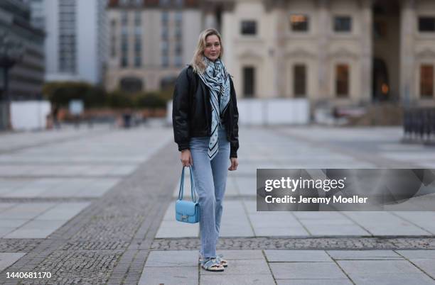 Mandy Bork wearing Agolde blue jeans, Hermes Kelly black leather silver belt, Hermes Constance baby blue leather bag, Hermes fur baby blue Chypre...