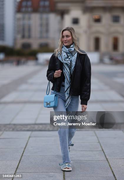 Mandy Bork wearing Agolde blue jeans, Hermes Kelly black leather silver belt, Hermes Constance baby blue leather bag, Hermes fur baby blue Chypre...