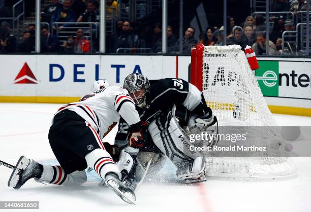 Andreas Athanasiou of the Chicago Blackhawks skates the puck against Jonathan Quick of the Los Angeles Kingsin the third period at Crypto.com Arena...