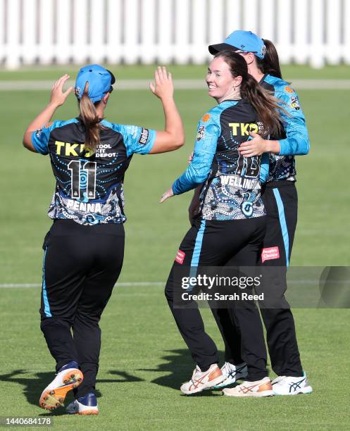 Amanda-Jade Wellington of the Adelaide Strikers celebrates withe team mates Madeline Penna of the Adelaide Strikers and Tahlia McGrath of the...