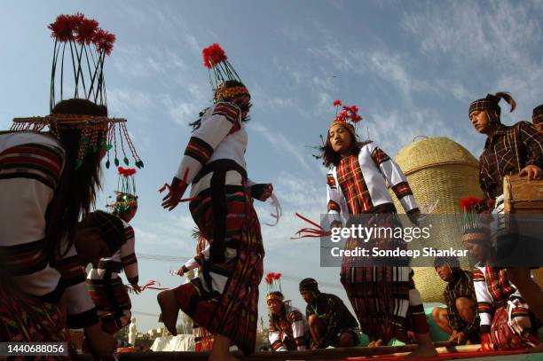 Dancers from Mizoram, a north eastern state in India perform 'Cheraw' a popular folk dance wearing bamboo headgear at a festival on the eve of...