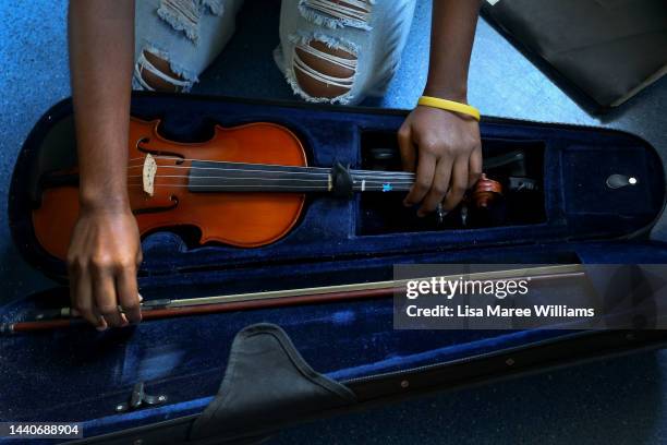 Noémie Fred of Ensemble Nabanga packs her violin into its case following a performance with other members at the Toowoomba Junior Grammar School on...