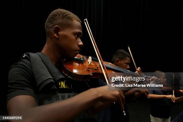 Dominique Kaltack, Pascal Manu-Harry and Gisèle Harris of Ensemble Nabanga play the violin during a workshop with members of the Queensland Symphony...