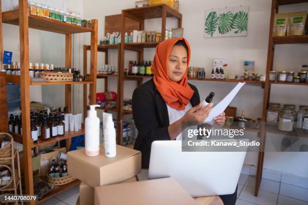 muslim store owner preparing product for delivery - cosmetic testing store stock pictures, royalty-free photos & images