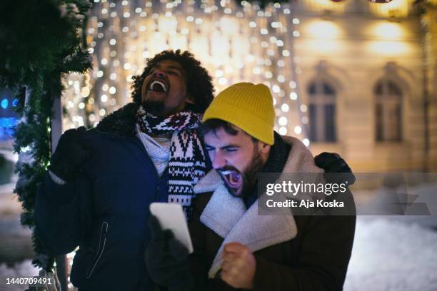 friends cheering for their team on the night out. - championship round two stock pictures, royalty-free photos & images