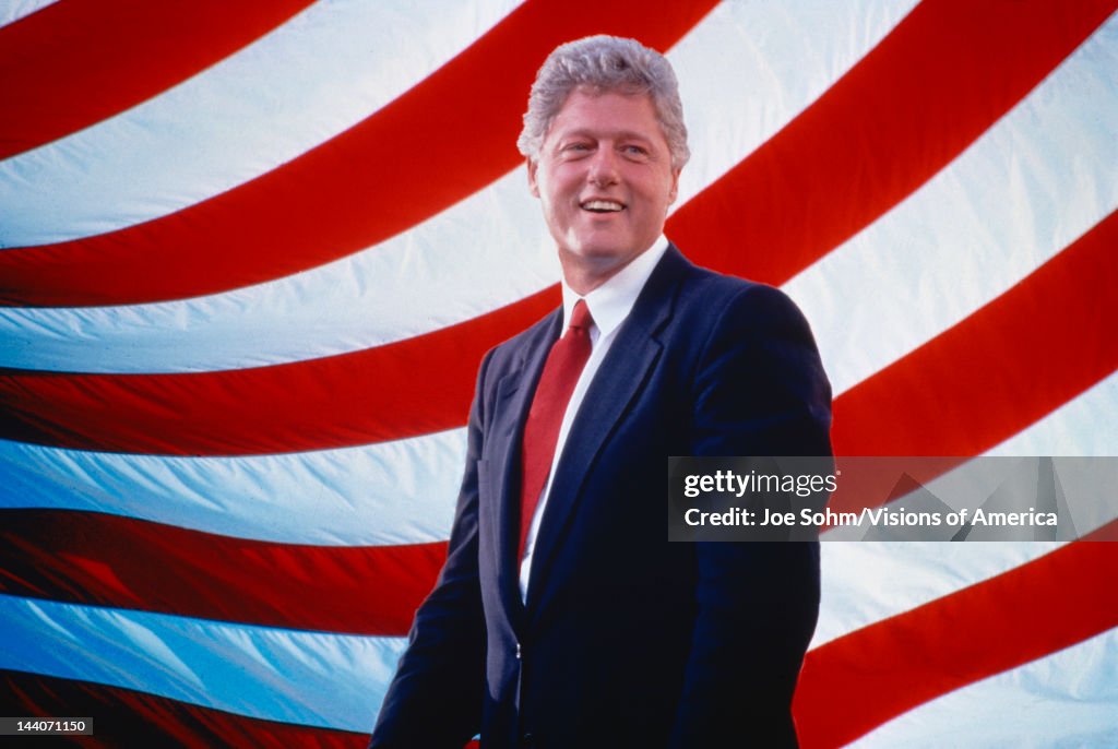 President William Jefferson Clinton in front of American flag stripes