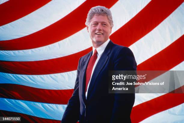 President William Jefferson Clinton in front of American flag stripes