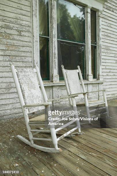 Rocking chairs on porch of southern house in disrepair along Highway 22 in Central Georgia