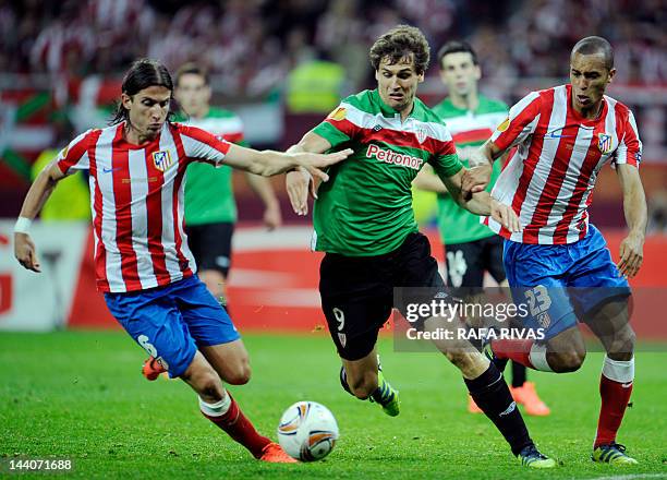 Athletic Bilbao's forward Fernando Llorente vies with Atletico Madrid's Brazilian defender Joa Miranda de Souza and Atletico Madrid's Brazilian...