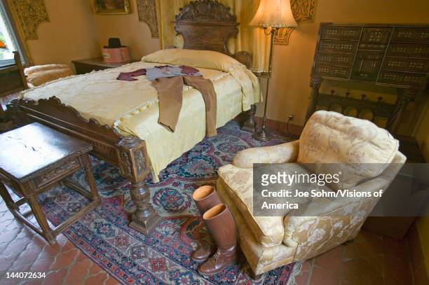 Riding boots and outfit displayed in guest room of Hearst Castle, San Simeon, California