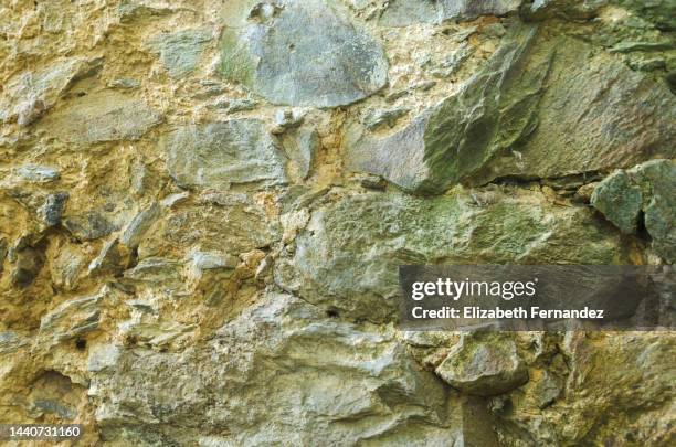 ancient stone wall texture background - mossy rock wall stock pictures, royalty-free photos & images