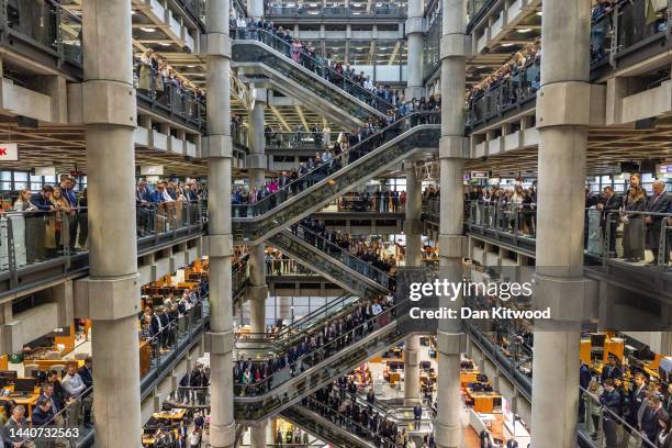 Employees line the balconies and escalators of the Lloyd's of London building during the annual armistice service of remembrance at Lloyd's of London...