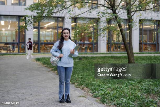 frontal full-length portrait of young female college student - full frontal female stock pictures, royalty-free photos & images