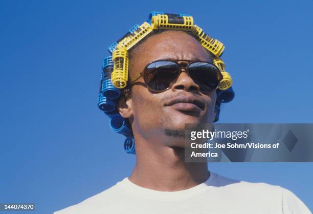 An African-American man wearing hair curlers, Watts, Los Angles, CA