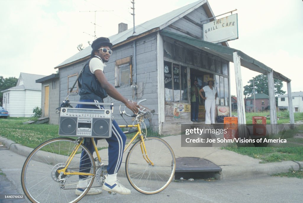 An young African-American man on his bicycle with his boom box, Cairo, IL