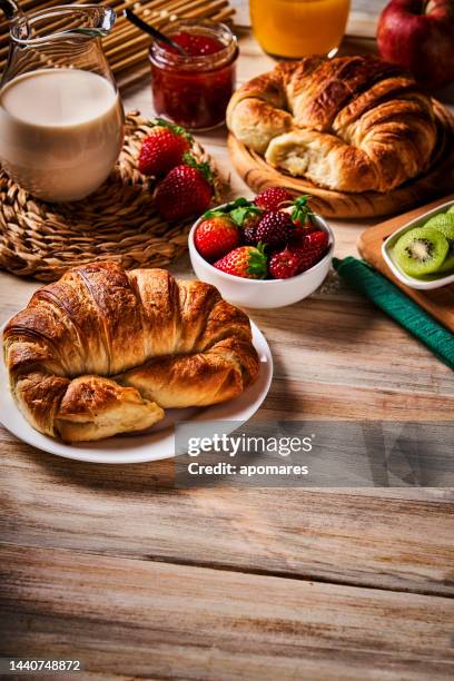 breakfast with cup of coffee, croissants, marmalade, and fruits on wooden table - marmalade sandwich stock pictures, royalty-free photos & images