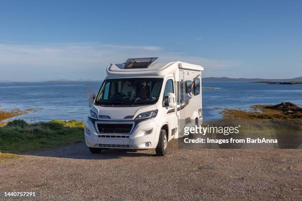 on tour with a camper van - parked with an ocean view - campervan stockfoto's en -beelden